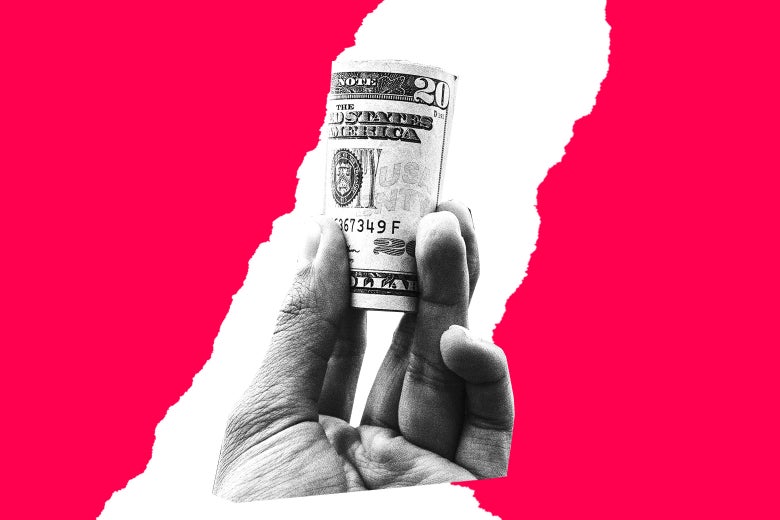A hand holding a roll of cash.